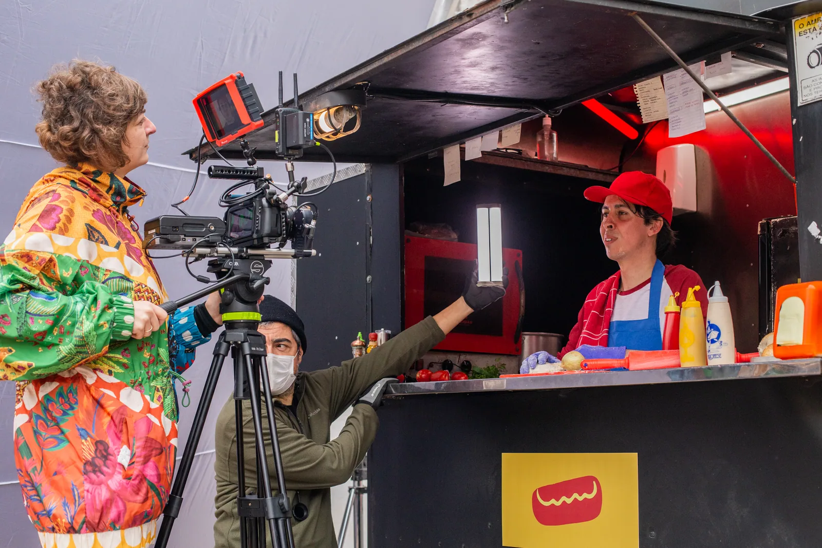 Interview being filmed at a food truck, with camera and handheld bounce